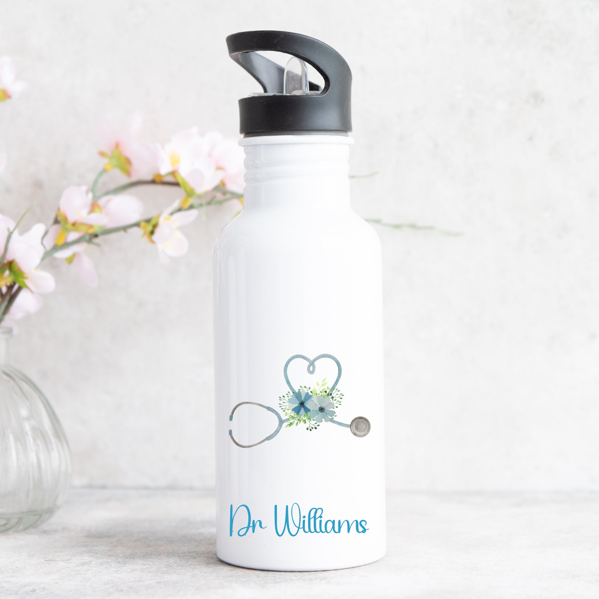 personalised water bottle with straw featuring love heart stethescope design for doctor or nurse with name on the front