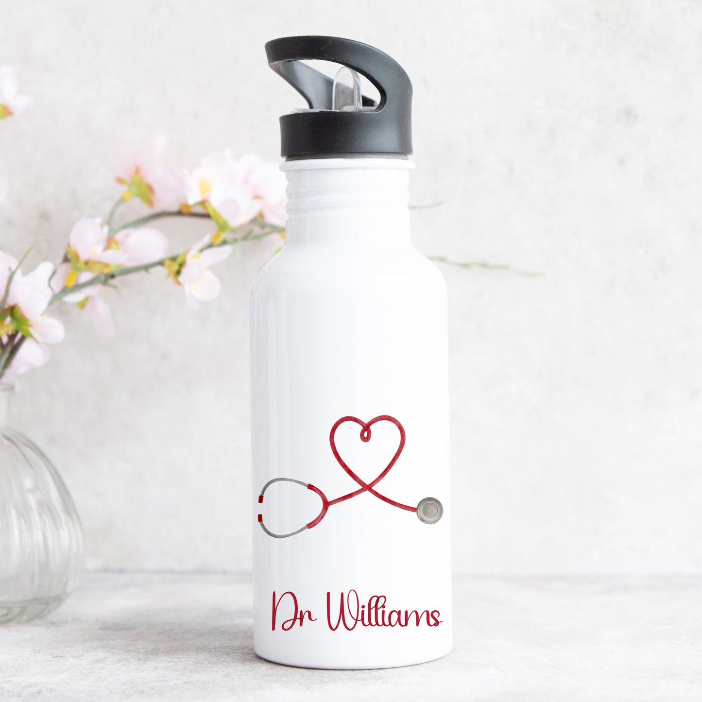 personalised water bottle with straw featuring love heart stethescope design for doctor or nurse with name on the front
