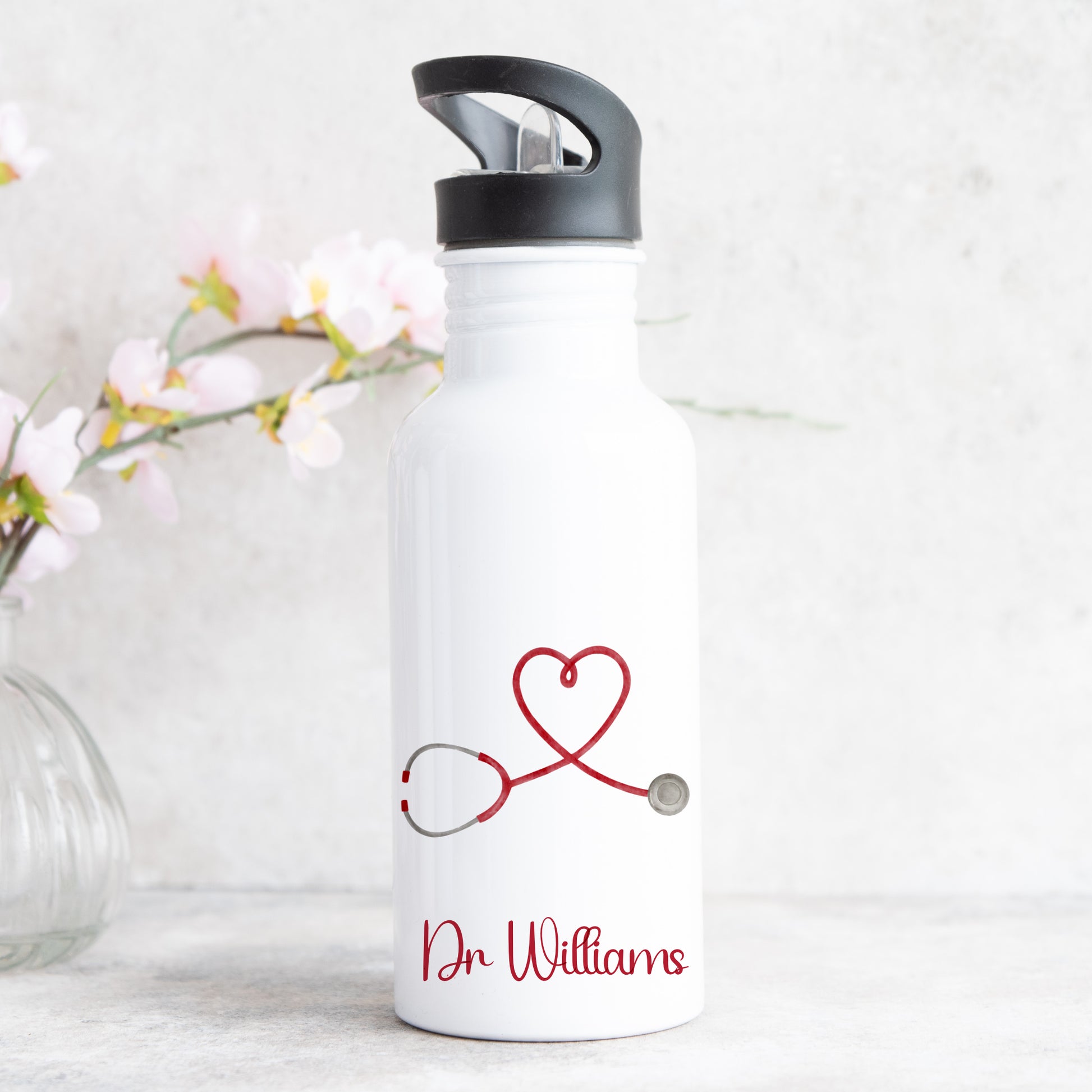 personalised water bottle with straw featuring love heart stethescope design for doctor or nurse with name on the front