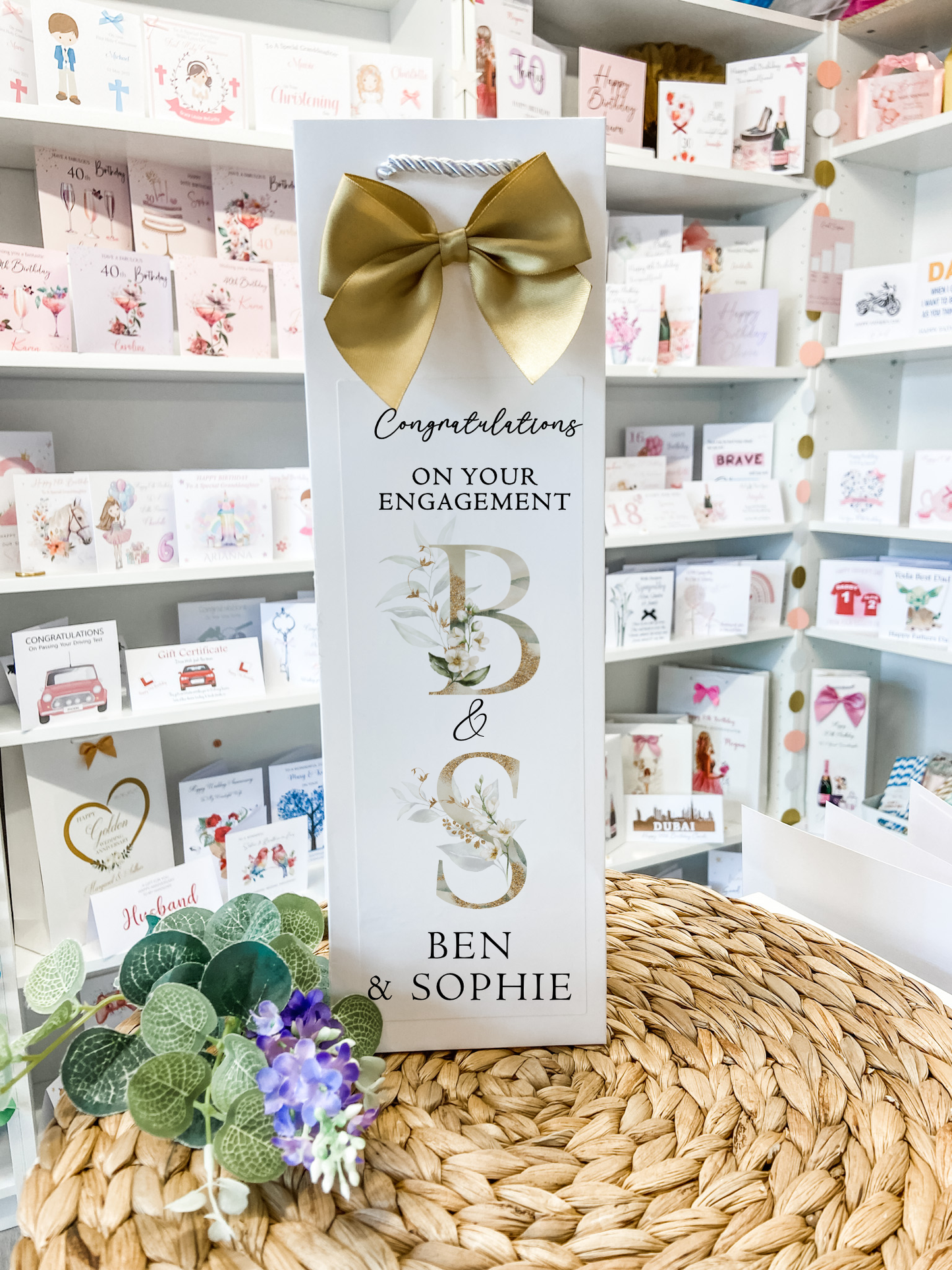 a card with a bow on top of a table
