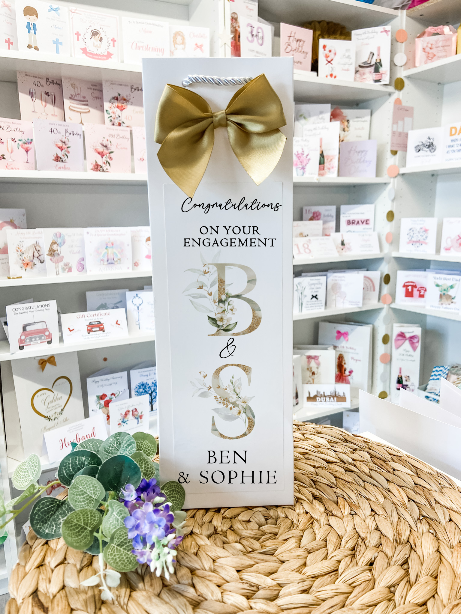 a card with a bow on top of a table