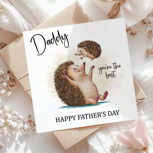 A greeting card with an illustration of a hedgehog and a baby hedgehog, along with the text "Daddy you're the best" and "Happy Father's Day".