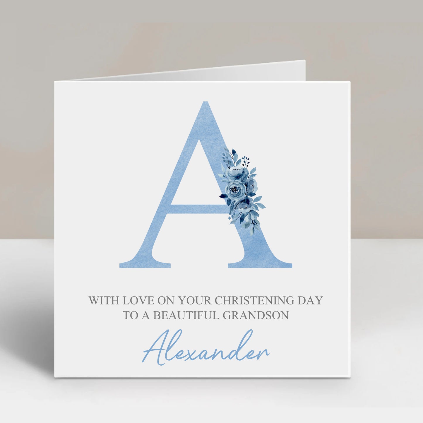a greeting card with a blue letter and flowers