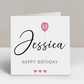 a white birthday card with a pink balloon