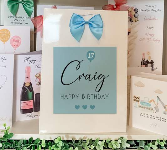 a birthday card with a blue bow on it