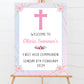 a welcome sign with a pink cross on it