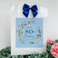 a happy 80th birthday card with a blue bow