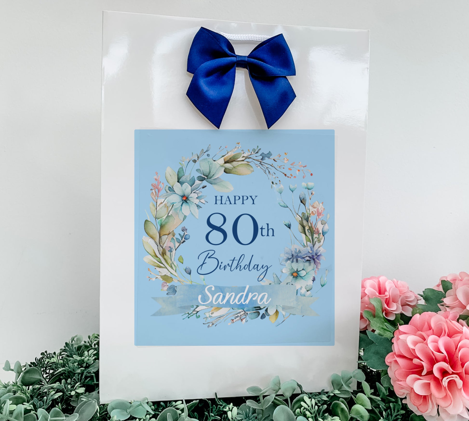 a happy 80th birthday card with a blue bow