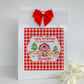 a red and white gingham bag with a red bow