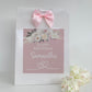 a pink birthday card with a pink bow on it