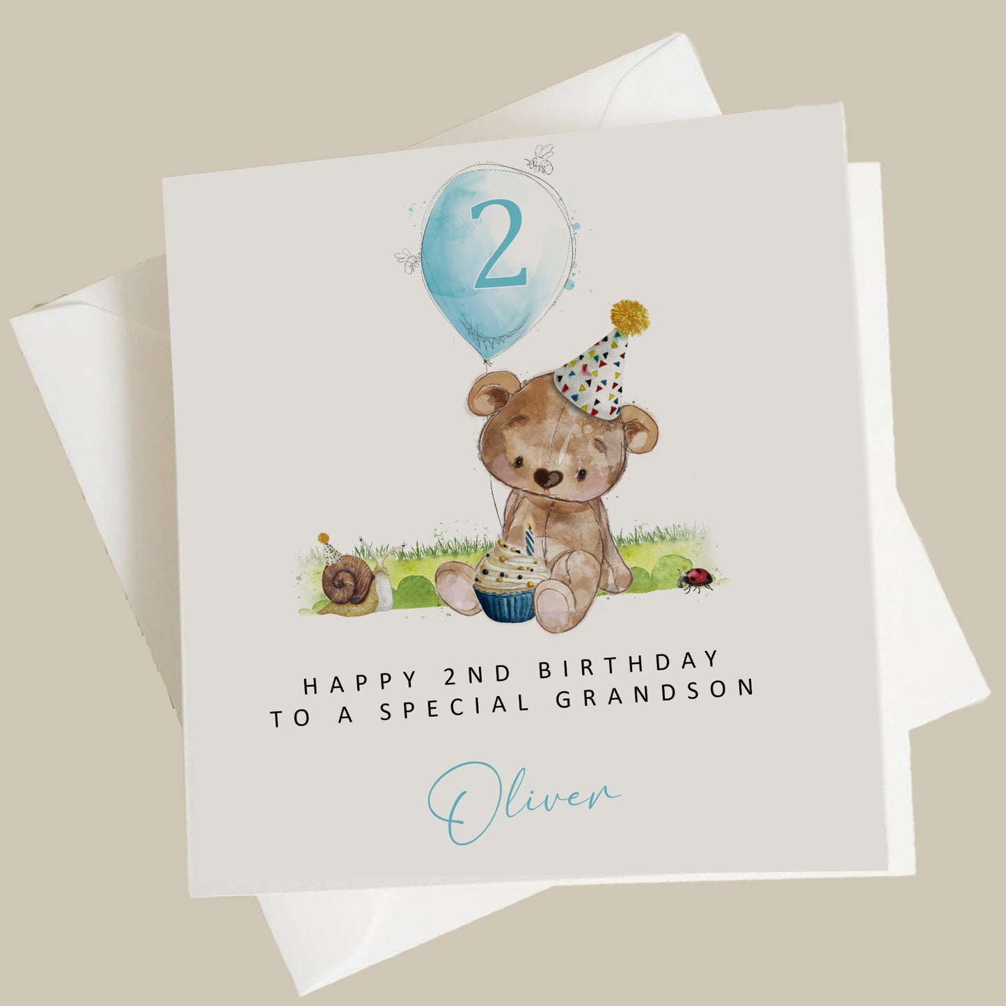 a birthday card with a teddy bear holding a cupcake