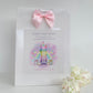 a birthday card with a pink bow on it
