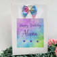 a birthday card with a bow on top of it