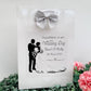 a paper bag with a picture of a bride and groom on it