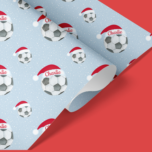 a christmas wrapping paper with soccer balls on it
