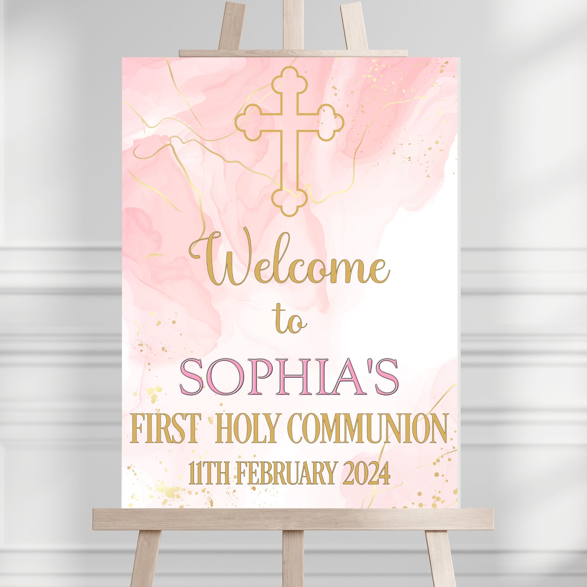 a pink and gold welcome sign on a easel