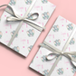 a couple of wrapped presents sitting on top of a pink table