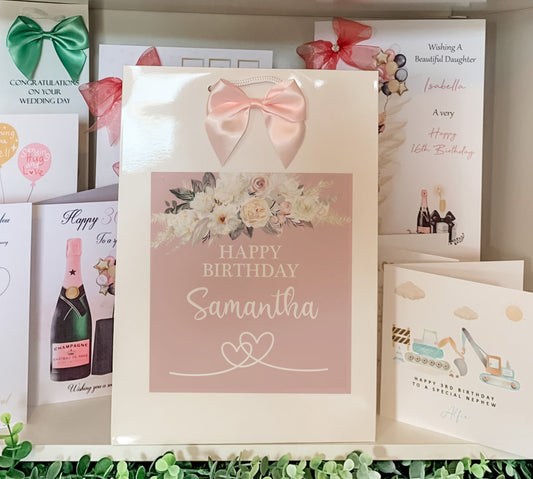 a birthday card with a pink bow on it