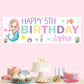 a birthday banner with a mermaid sitting on top of a table