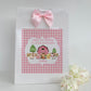 a pink and white bag with a pink bow on it