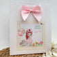 a card with a picture of a girl with a pink bow