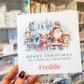 a person holding up a christmas card in a store