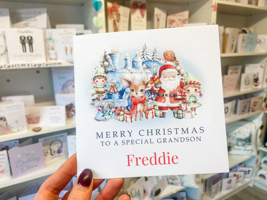 a person holding up a christmas card in a store