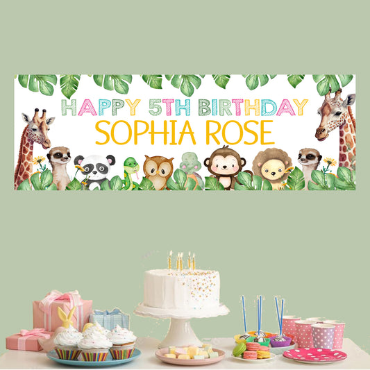 a birthday banner with animals and a cake