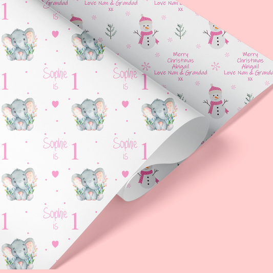a christmas wrapping paper with elephants and snowman on it