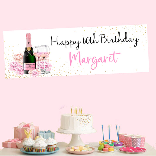 a birthday banner with a bottle of wine and a cake