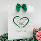 a white card with a green heart on it