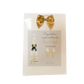 a card with a bottle of champagne and a bow